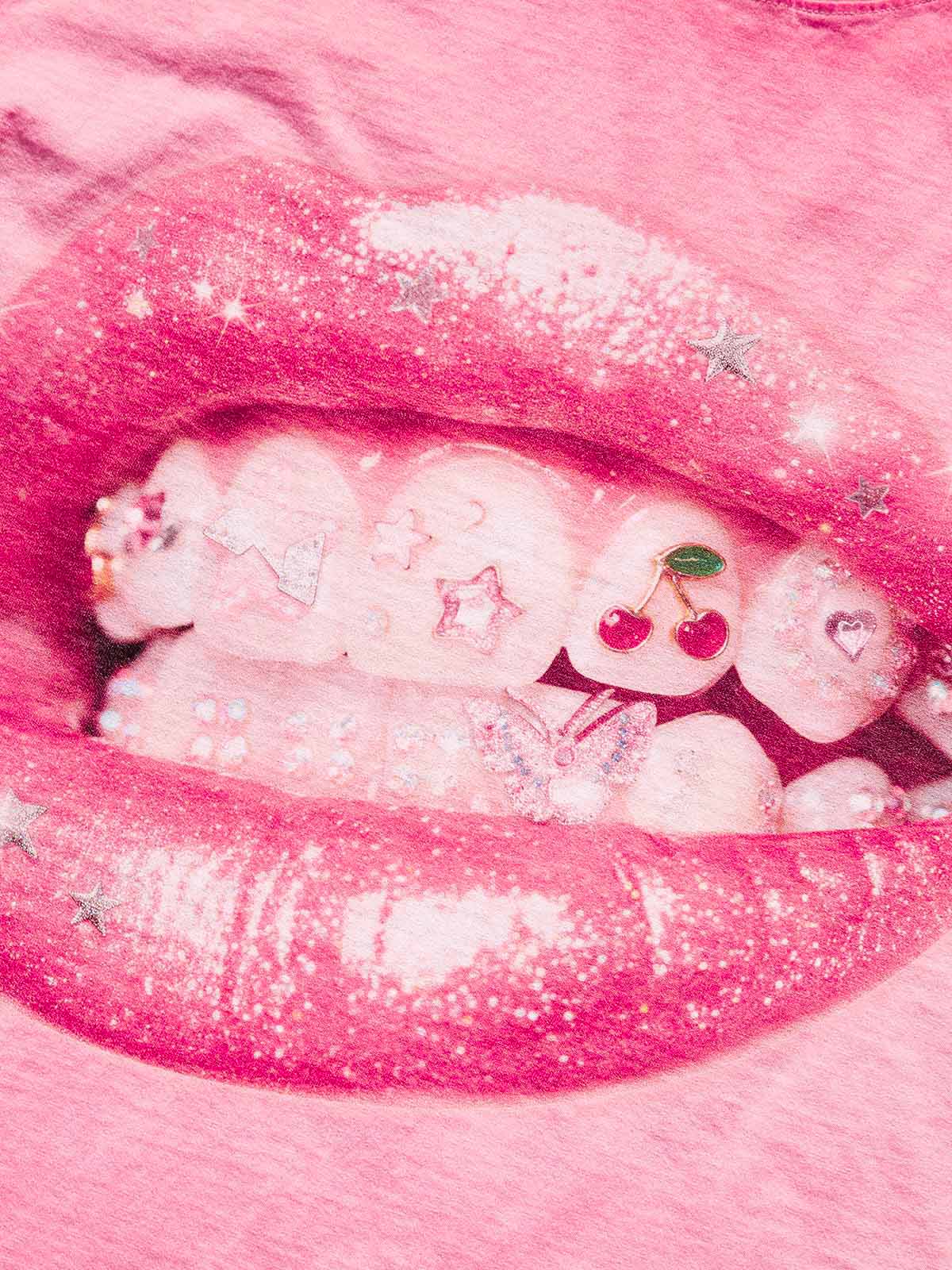 Close-up of the lip graphic showing the intricate glitter textures, cherry charms, and butterfly jewelry details.