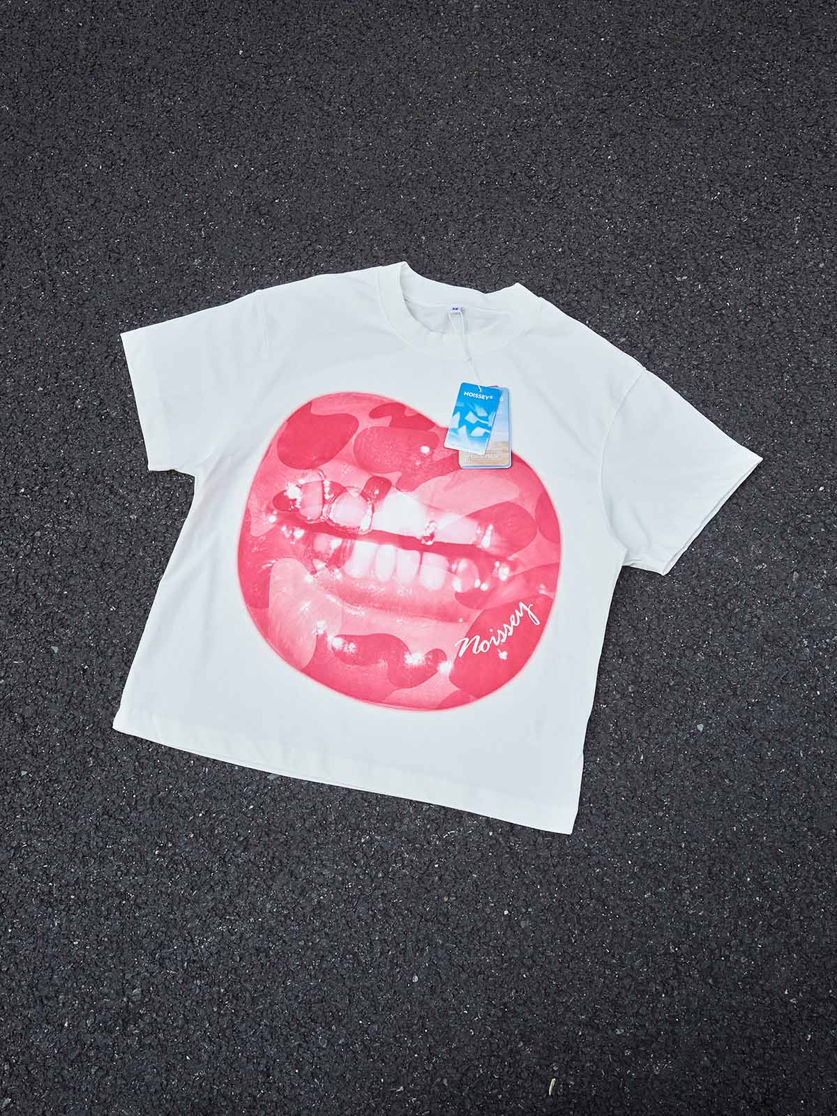 Flat lay view of the Pink Camo T-shirt featuring the lip graphic art print on a white background.